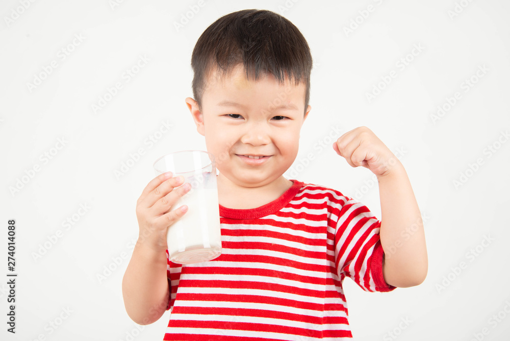 Little Asian boy drinking milk from th glass with happy face Little Asian boy drinking milk from th glass with happy face