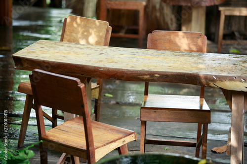 Rain drops on old wooden chairs, rain with old wooden chairs, wooden benches and nature © CStock