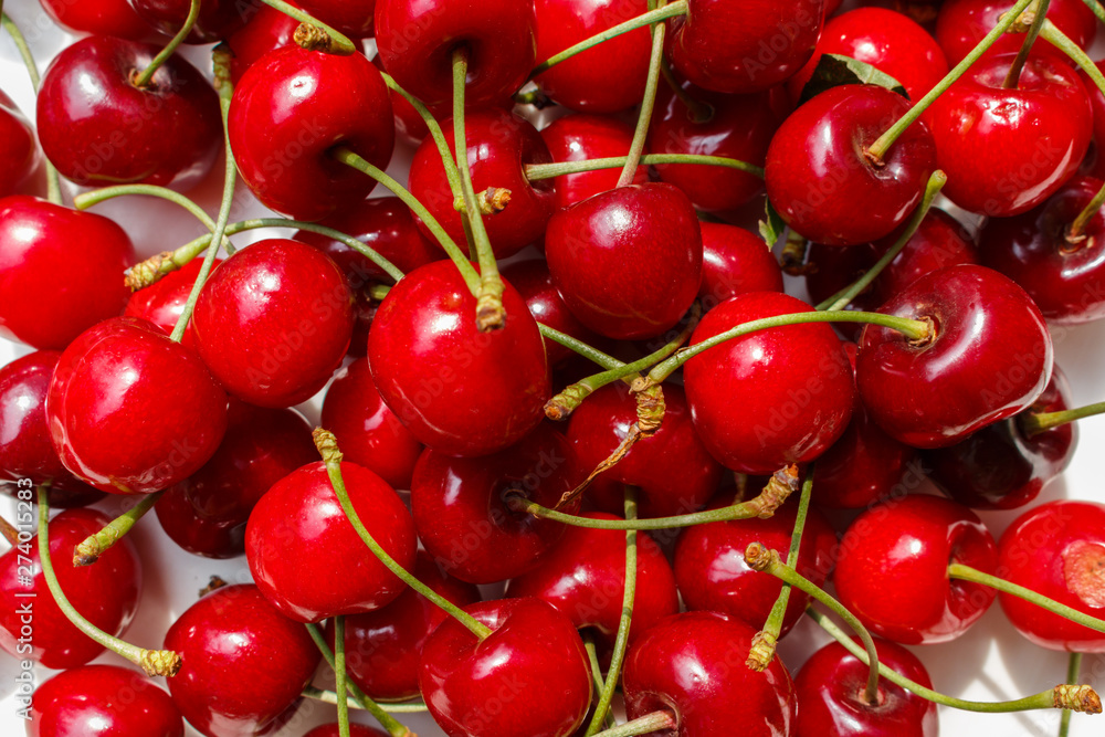 close-up cherries and sweet cherry harvest season. berries background for design concepts. close-up cherries and sweet cherry harvest season. berries background for design concepts.