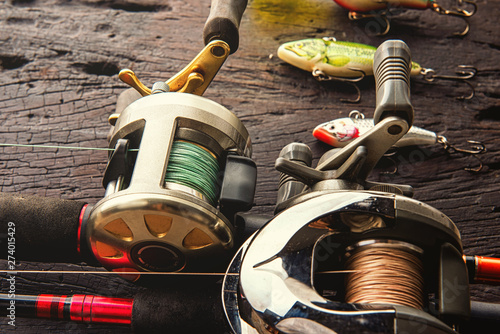 Bilde på lerret Fishing lures, hooks and accessories on darken wooden background