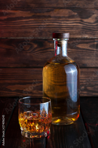 Bottle of whiskey on a wooden background.Studio photography.