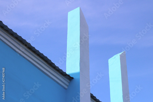 white vertical columns rush into the blue sky. Abstract architectural modern photo