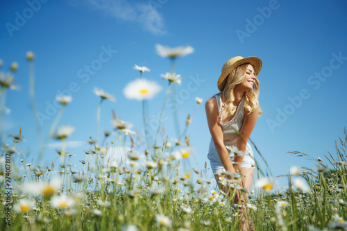 Beautiful woman in the field with flowers. 