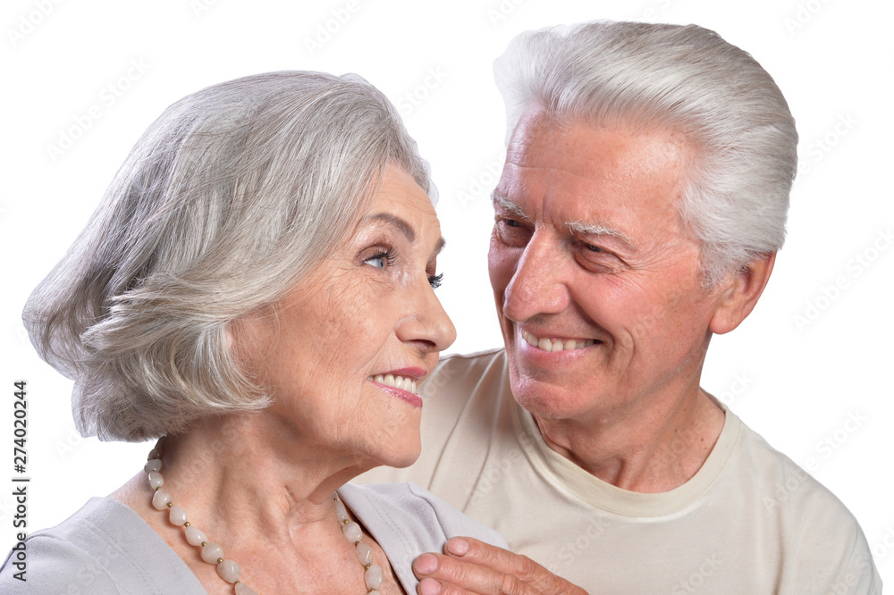 Happy senior couple embracing and posing on white background Happy senior couple embracing and posing on white background