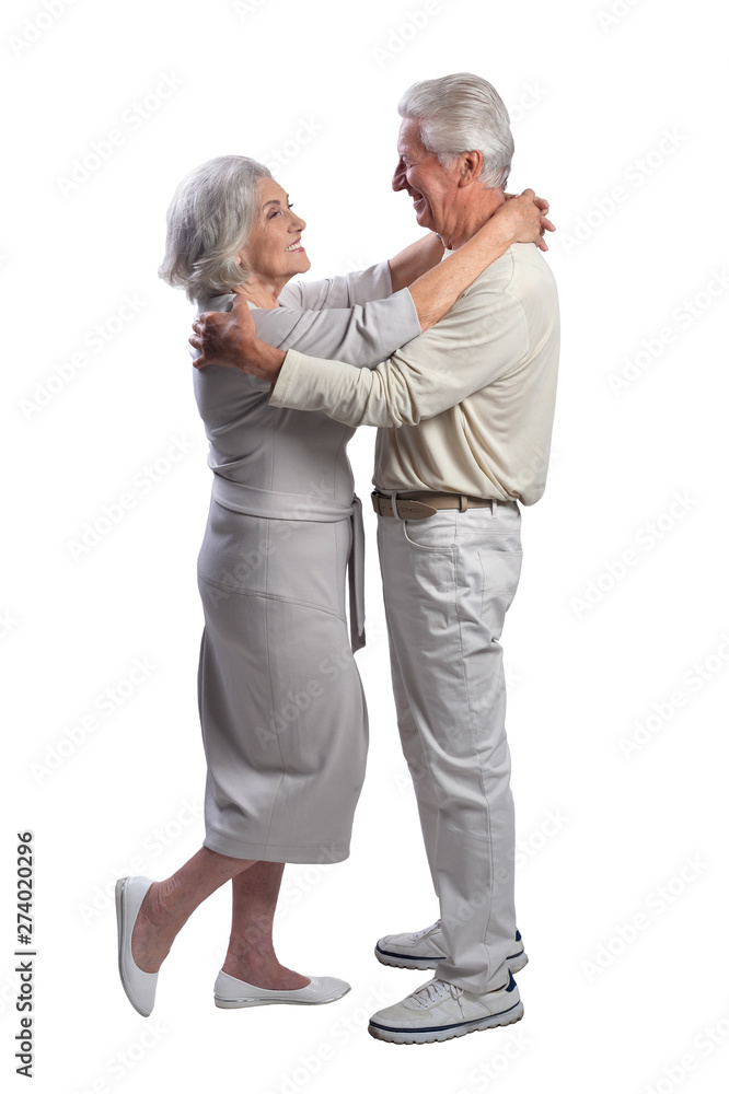 Happy senior couple embracing and posing on white background Happy senior couple embracing and posing on white background
