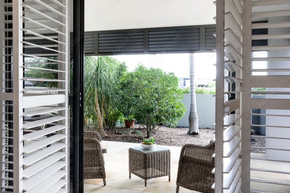 Two chairs with a mini table in between facing the lawn. Two chairs with a mini table in between facing the lawn.