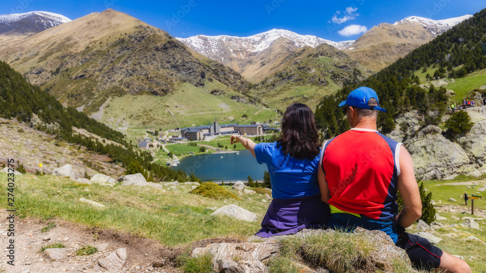 Two tourist in a nice valley in mountain Pyrenees of Spain (valley name is Vall de Nuria)