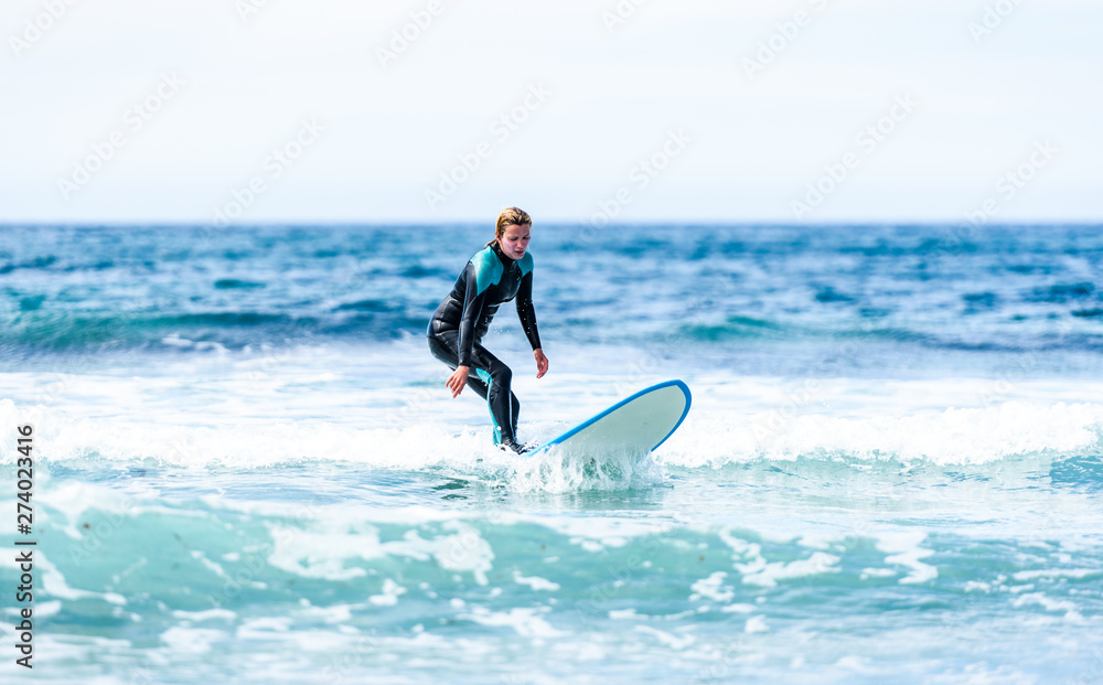 Surfer girl surfing with surfboard on waves in Atlantic ocean. Surfer girl surfing with surfboard on waves in Atlantic ocean.