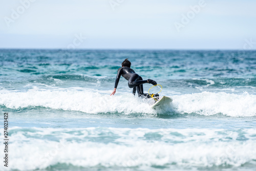 Surfer man with surfboard is falling in water.
