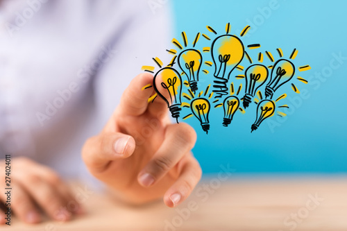  holding illuminated light bulb, idea, innovation and inspiration concept.