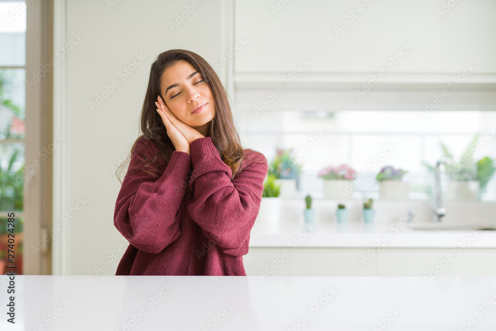 Young beautiful woman at home sleeping tired dreaming and posing with hands together while smiling with closed eyes. Young beautiful woman at home sleeping tired dreaming and posing with hands together while smiling with closed eyes.
