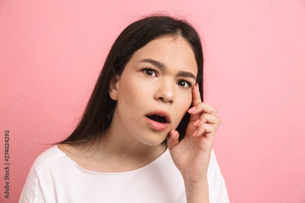 Portrait closeup of youthful excited girl in casual wear looking at camera with open mouth Portrait closeup of youthful excited girl in casual wear looking at camera with open mouth