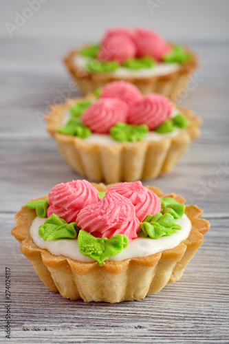 Dessert in the form of cakes with protein cream on wooden background