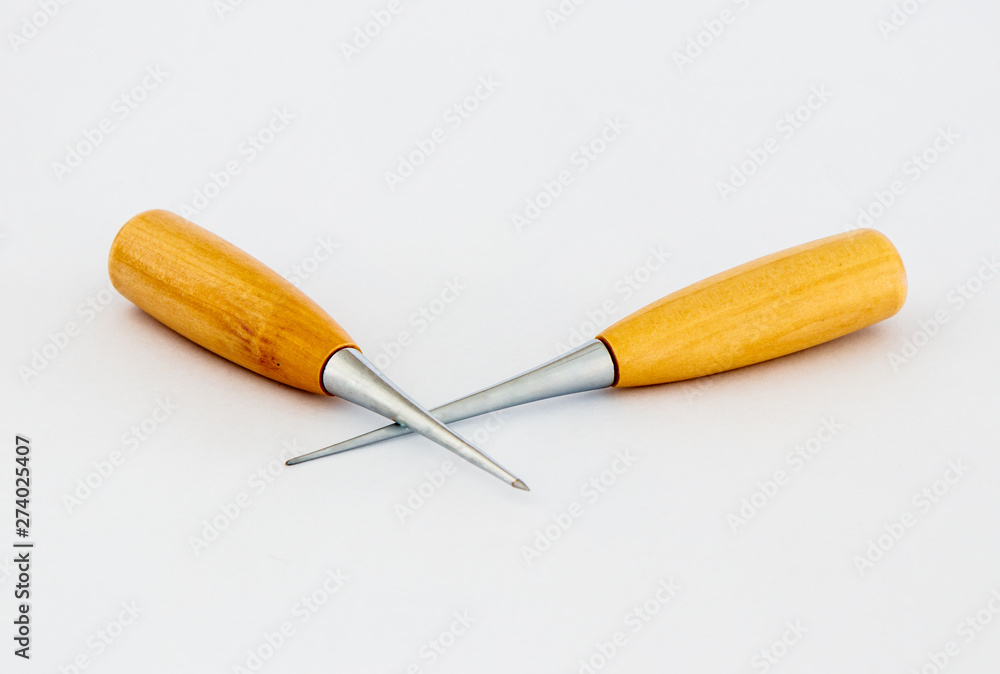 Fototapeta premium Two awls for shoemakers with a wooden handle on a white background