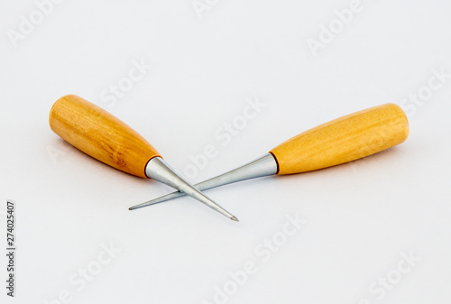 Two awls  for shoemakers with a wooden handle on a white background photo