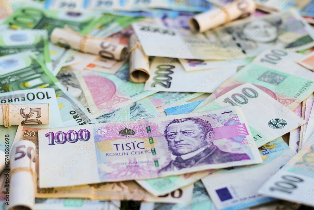 Obraz premium Scattered Euro and Czech Koruna bills