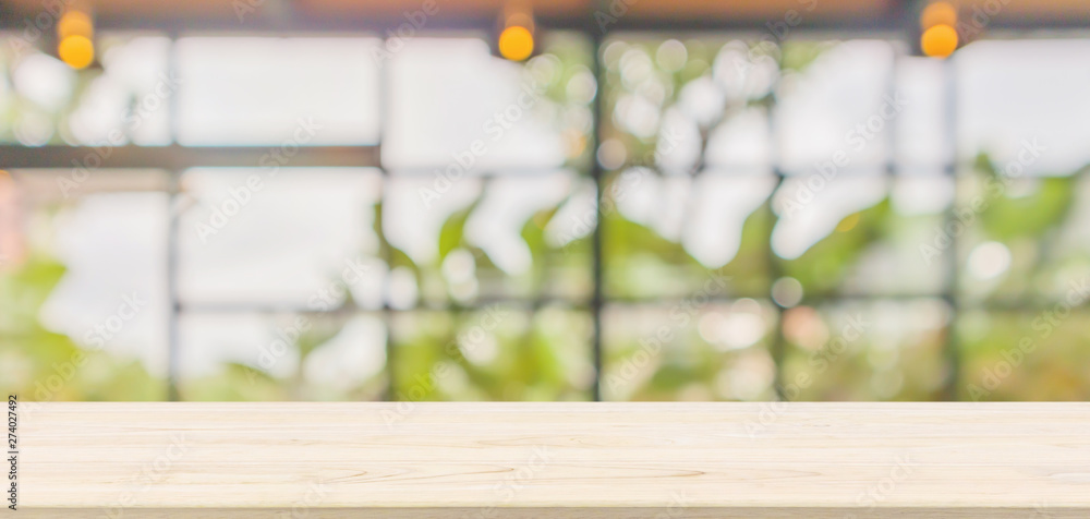 Empty wood table top with abstract blur coffee shop or cafe restaurant ...