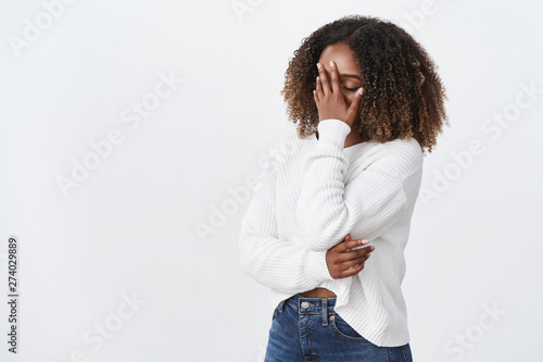 Oh god why me. Portrait tired exhausted emotive african-american curly-haired woman facepalming press palm face close eyes exhausted, look bothered annoyed dumb pick-up lines, white background photo