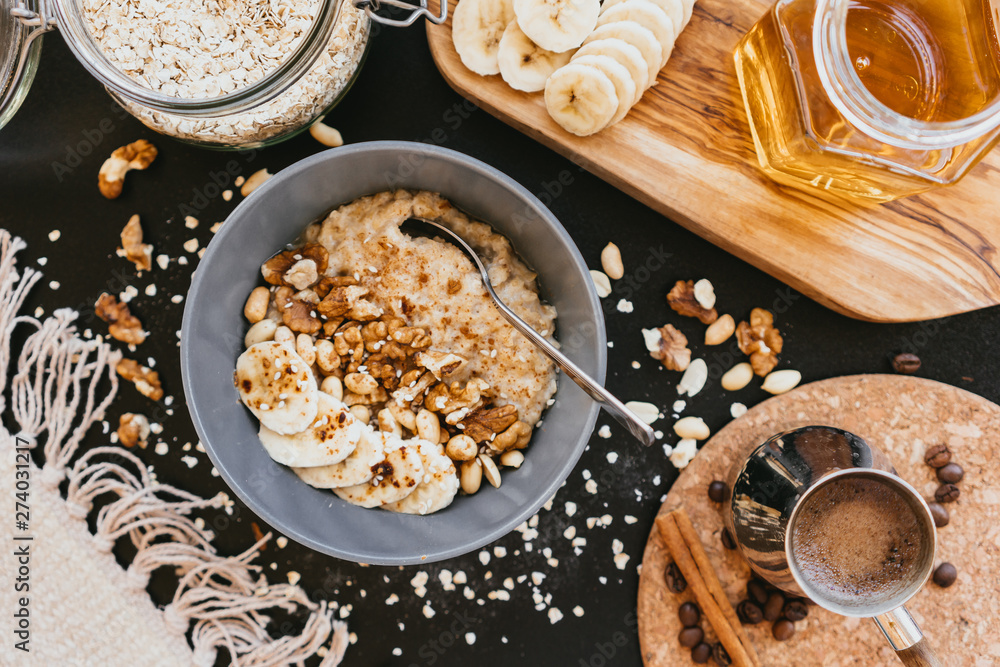 Healthy breakfast oatmeal bowl with banana and nuts Healthy breakfast oatmeal bowl with banana and nuts