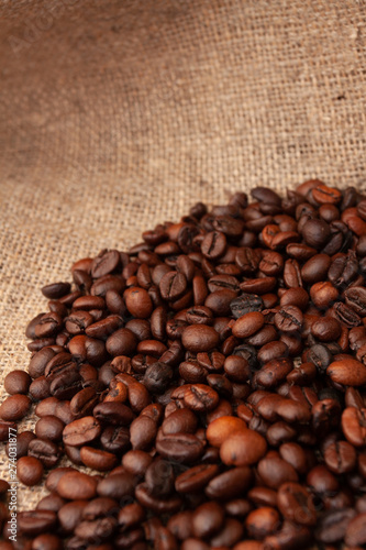 Coffee beans on burlap background