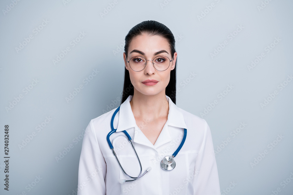 Close up photo beautiful amazing she her lady young doctor first working day hospital ready begin start strict not smiling wear phonendoscope white science costume specs isolated grey background Close up photo beautiful amazing she her lady young doctor first working day hospital ready begin start strict not smiling wear phonendoscope white science costume specs isolated grey background