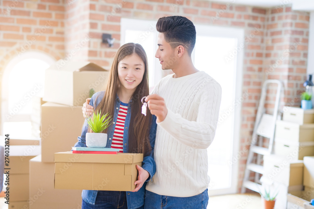 Young asian couple holding keys of new house, smiling happy and excited moving to a new apartment Young asian couple holding keys of new house, smiling happy and excited moving to a new apartment