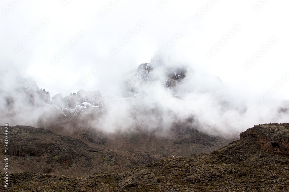 Dramatic landscape with mountain in the fog and clouds