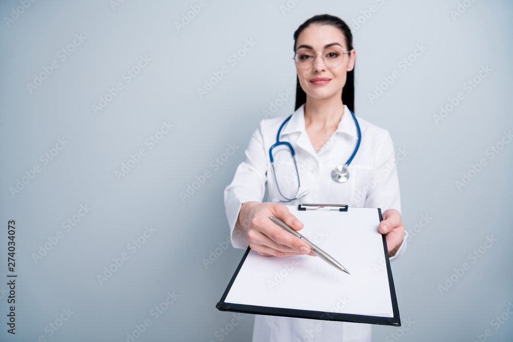Close up photo beautiful she her lady doctor hospital showing place signing list patient anamnesis insurance wear phonendoscope white science costume specs eyeglasses eyewear isolated grey background Close up photo beautiful she her lady doctor hospital showing place signing list patient anamnesis insurance wear phonendoscope white science costume specs eyeglasses eyewear isolated grey background