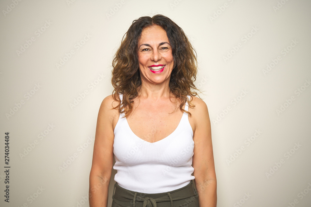 Middle age senior woman standing over white isolated background with a happy and cool smile on face. Lucky person. Middle age senior woman standing over white isolated background with a happy and cool smile on face. Lucky person.