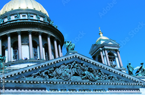 St. Isaac`s Cathedral in St. Petersburg. Сlose-up of the dome and fresco. Summer, clean blue sky, sunny. photo