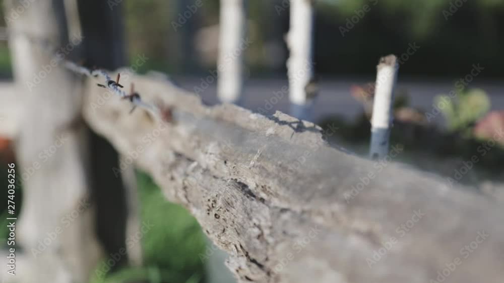 Rack focus of a countryside barbed wire fence.