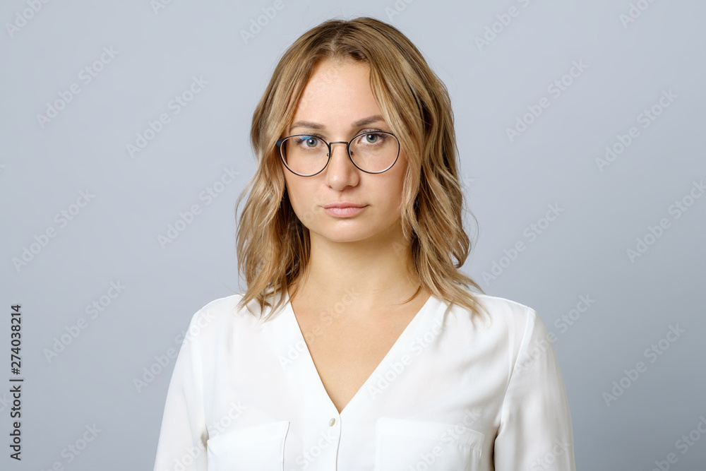 Picture of sad woman posing isolated over grey Picture of sad woman posing isolated over grey
