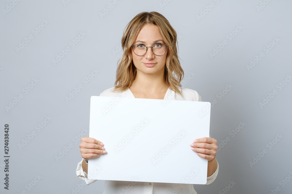 Pretty young woman holding empty blank board isolated Pretty young woman holding empty blank board isolated