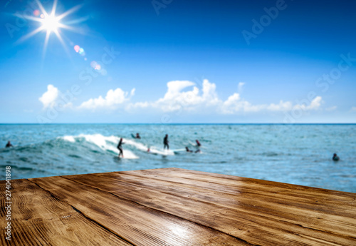 Summer desk of free space and surfers on beach. Summer time and ocean landscape  #274041898