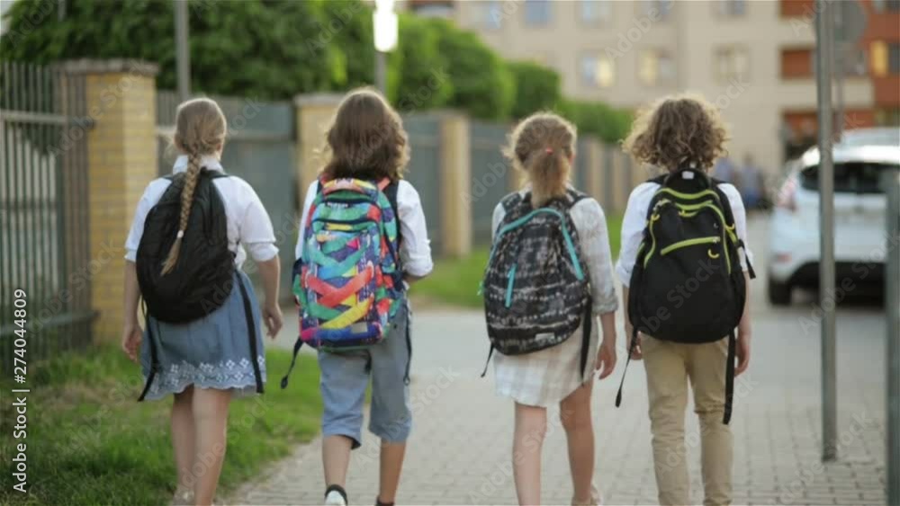 Children Are Going to School. They Have A Lot of Fun Because Today is Their First Day at School. The view from the back side Children Are Going to School. They Have A Lot of Fun Because Today is Their First Day at School. The view from the back side