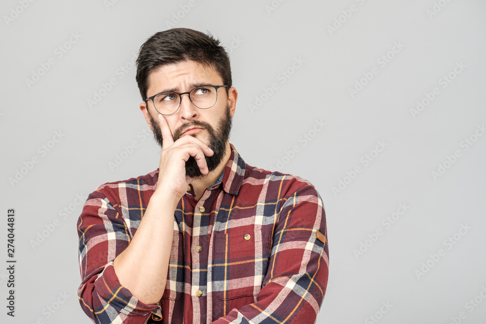 Portrait of focused smart male model with with thoughtful determined expression Portrait of focused smart male model with with thoughtful determined expression