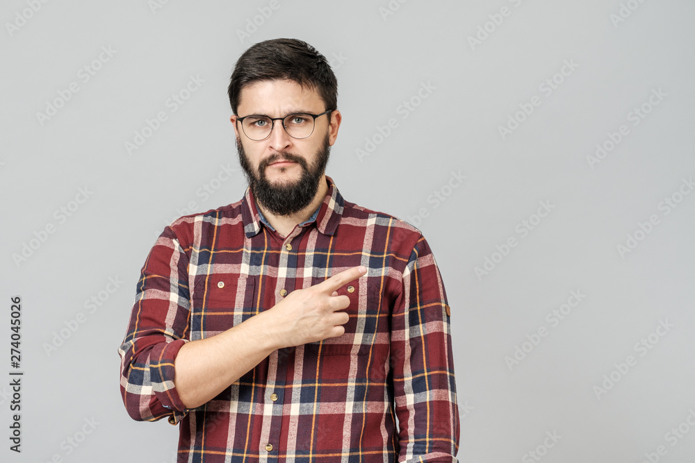 Beautiful bearded guy pointing aside Beautiful bearded guy pointing aside