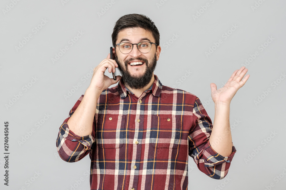Cheerful happy young man laughing smiling talking on phone Cheerful happy young man laughing smiling talking on phone
