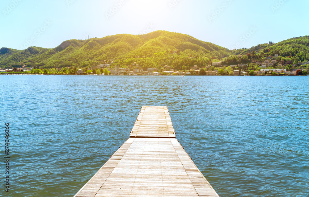 Pier on the beautiful summer Como lake in Italy.