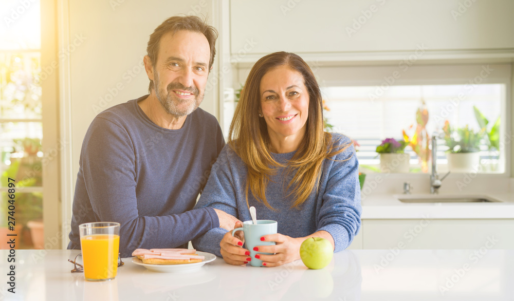 Beautiful romantic middle age couple having healthy breaskfast in the morning at home