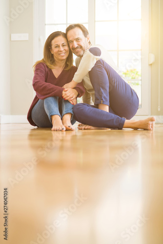 Beautiful romantic couple sitting together on the floor at home