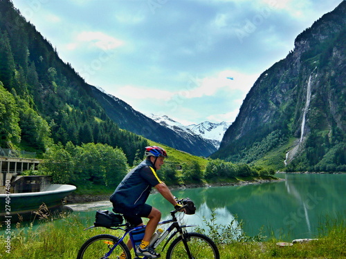 Austrian Alps-outlook of the cyclist and lake Stillupspeicher with waterfall © bikemp