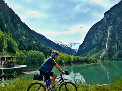 Austrian Alps-outlook of the cyclist and lake Stillupspeicher with waterfall