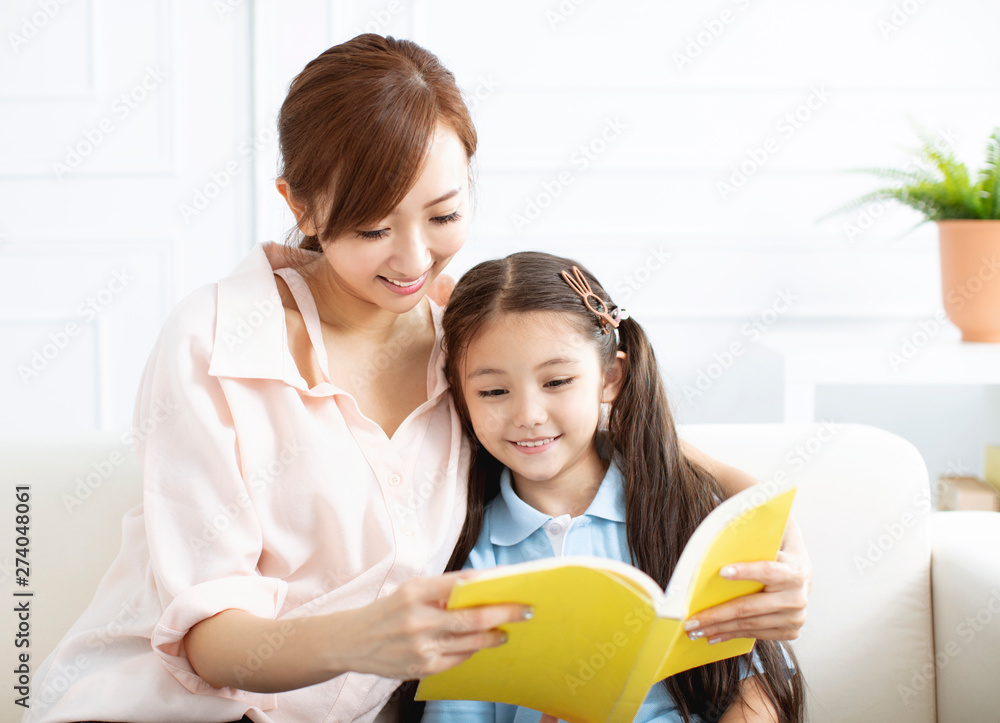 happy mother studying with little girl at home happy mother studying with little girl at home