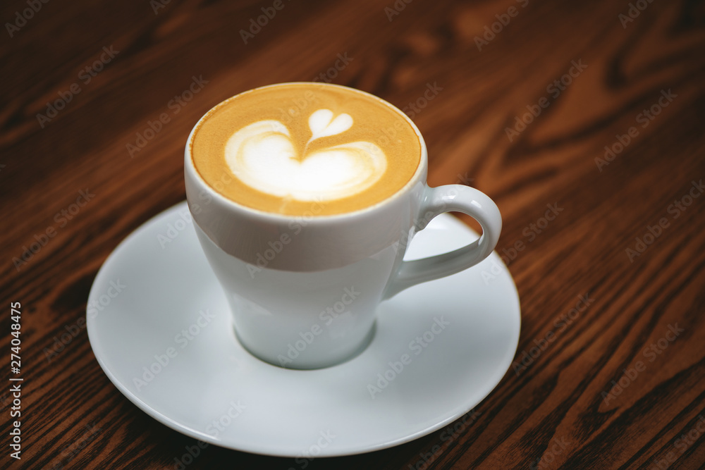 Cup of coffee with latte art on wooden background. Cup of coffee with latte art on wooden background.
