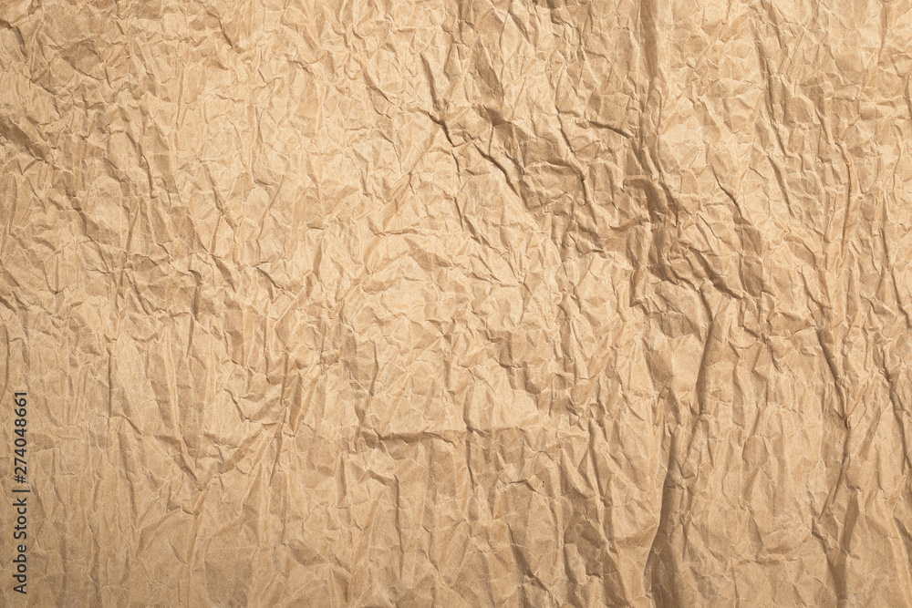 Wrinkled beige kraft paper background in sunlights Wrinkled beige kraft paper background in sunlights