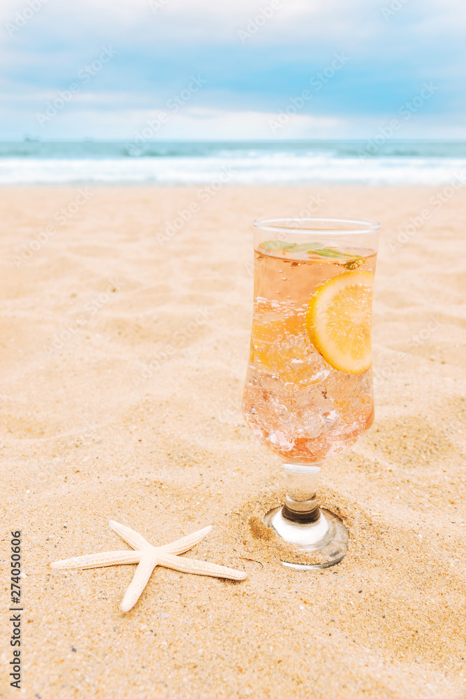 Glass of fresh drink with sliced citrus and starfish