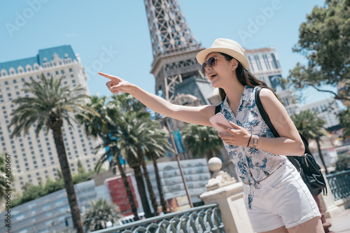 Photography Happy young girl tourist carry backpack pointing landmark in city usa
