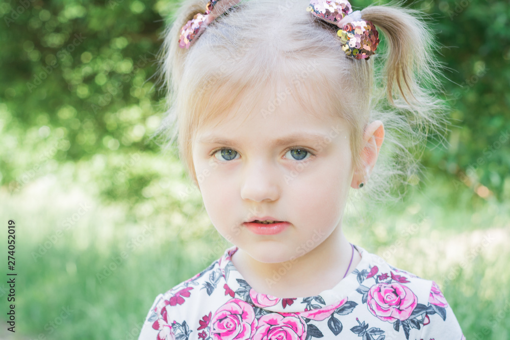 portrait of a little beautiful girl in a city park portrait of a little beautiful girl in a city park