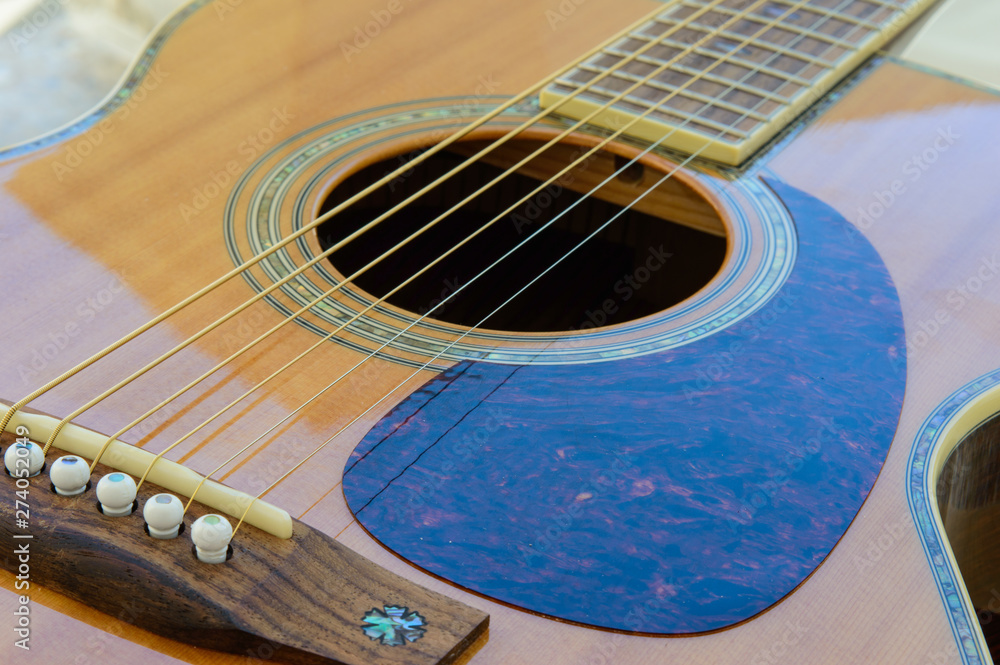 Obraz premium Acoustic Guitar detail - sound hole and scratch plate - from below
